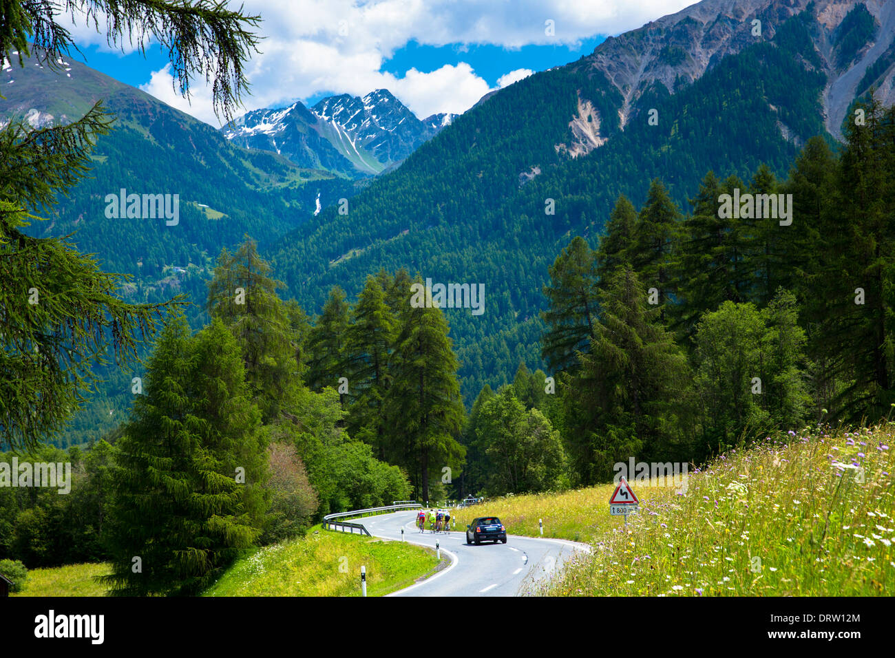 Auto il sorpasso di ciclisti sulla vacanza in giro per le Alpi svizzere, il Parco Nazionale Svizzero, Svizzera Foto Stock