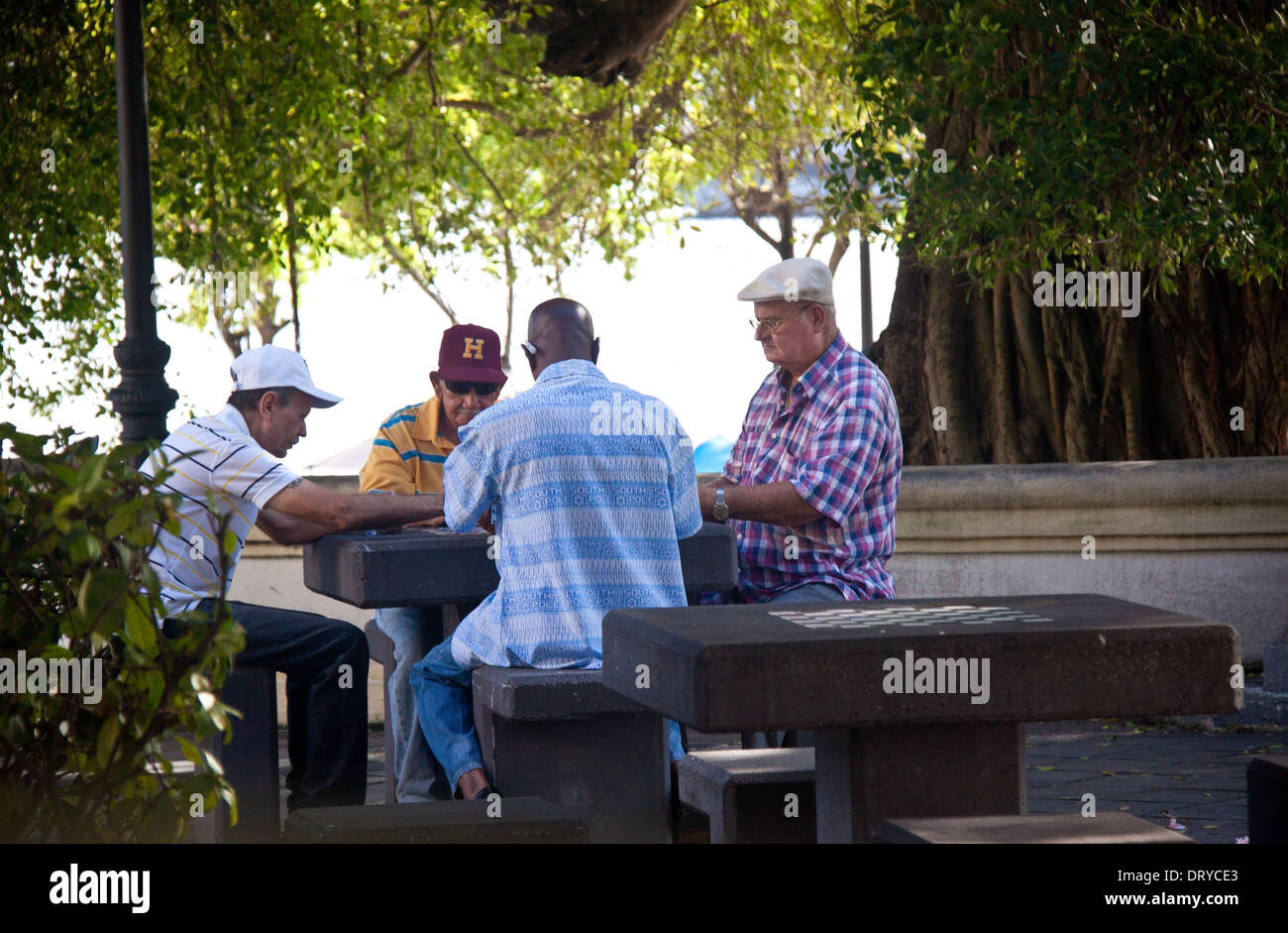 Gli uomini che giocano di Domino in un ombroso parco pubblico nella vecchia San Juan, Puerto Rico Foto Stock