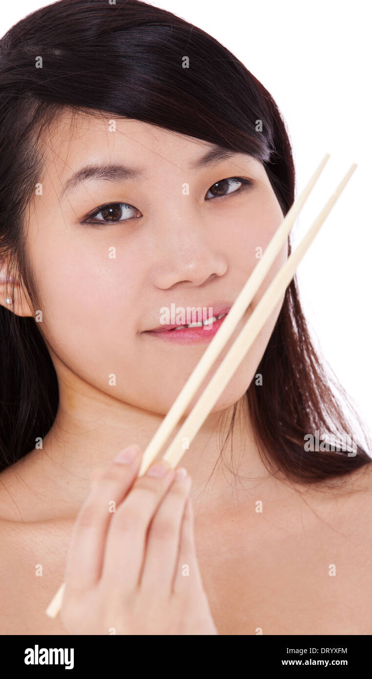 Attraente ragazza asiatica con bacchette. Tutto su sfondo bianco. Foto Stock