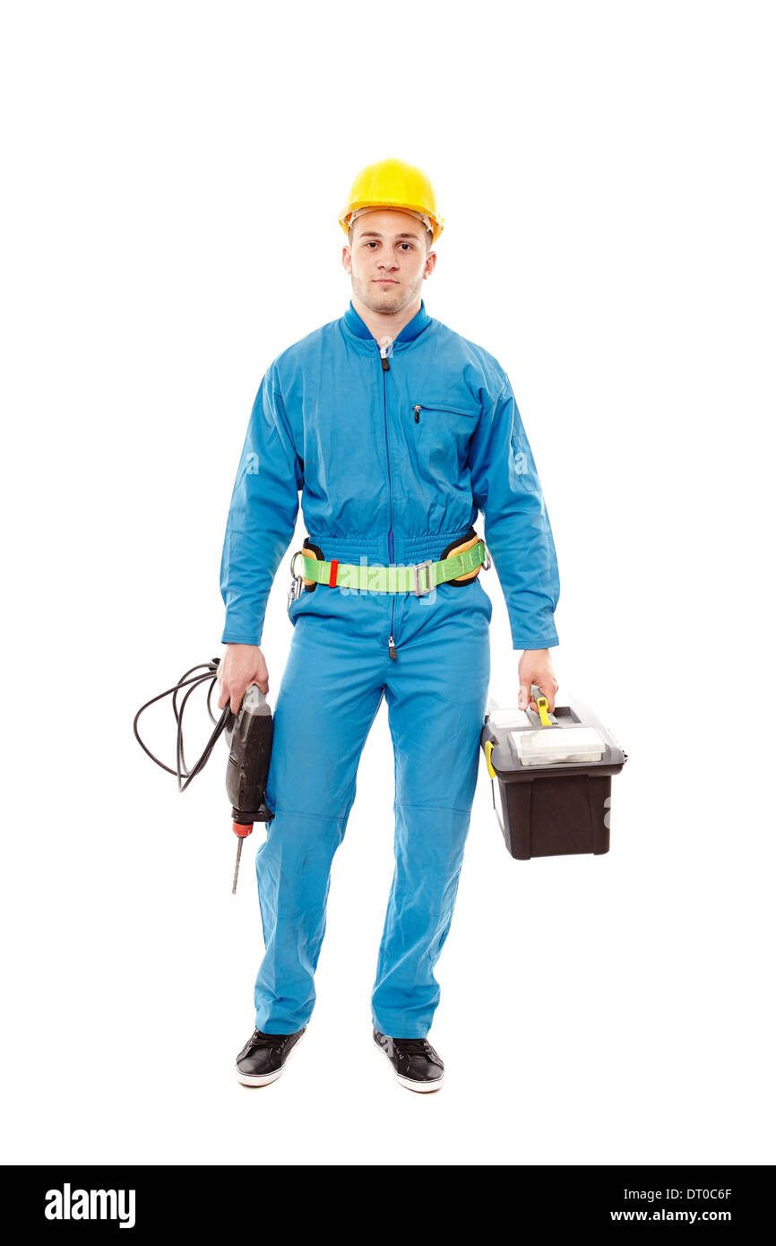 A piena lunghezza Ritratto di giovane lavoratore bello vestito in tuta e tenendo un trapano, isolate su sfondo bianco Foto Stock