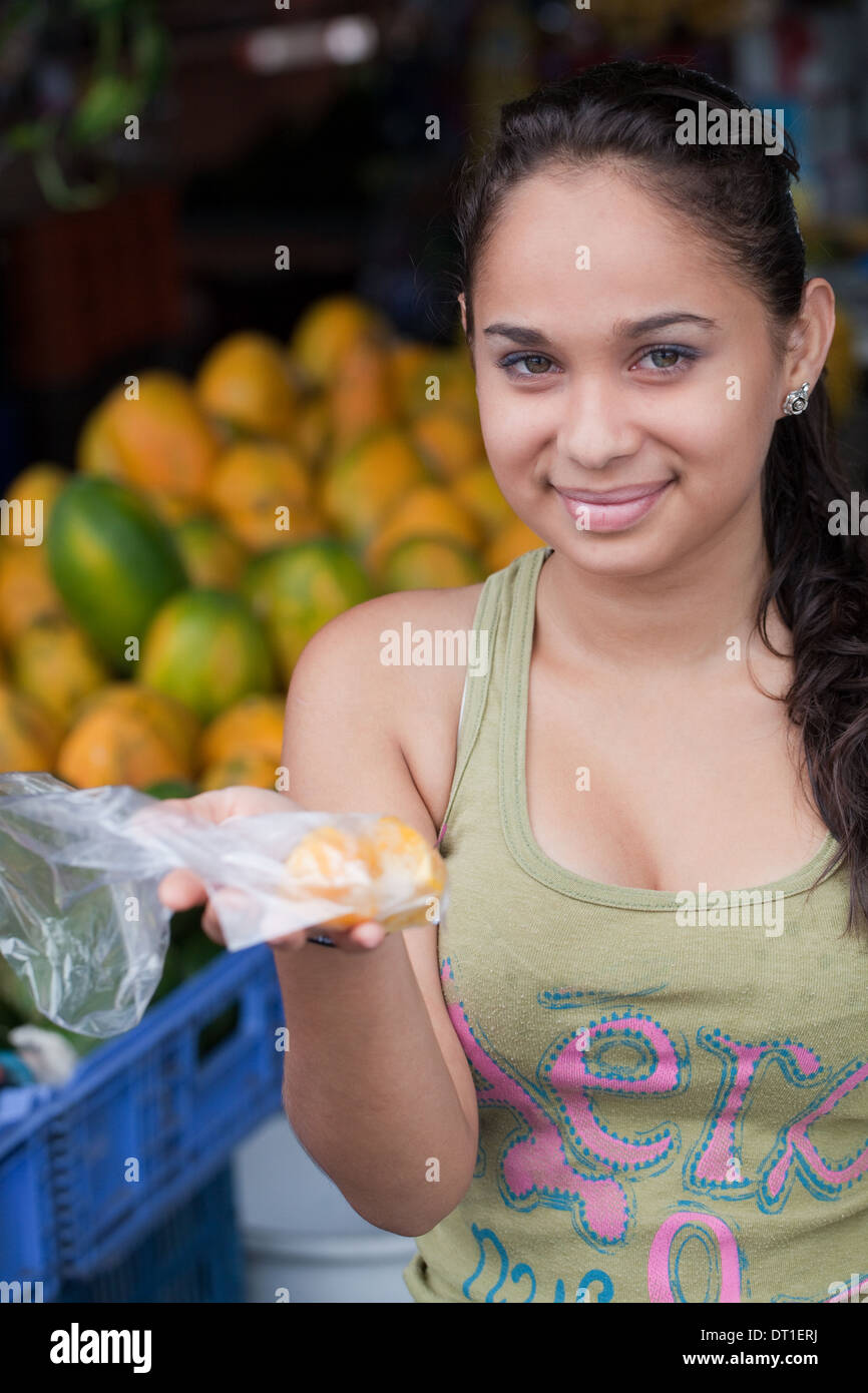 Costa Rican giovane donna di stallo del mercato titolare Condizionamento ordine per un cliente. Foto Stock