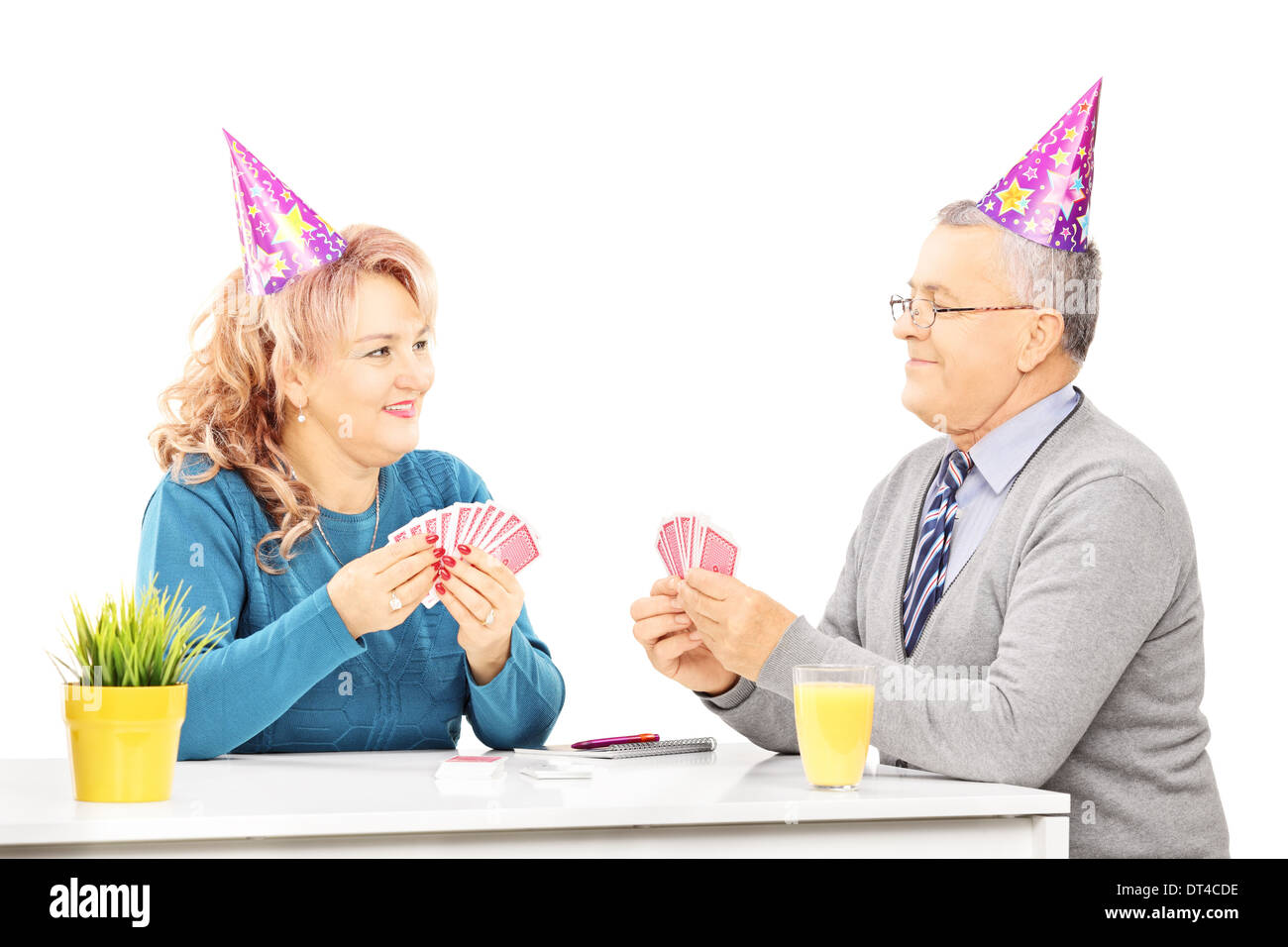 Coppia matura giocando a carte sul tavolo in un partito, Foto Stock