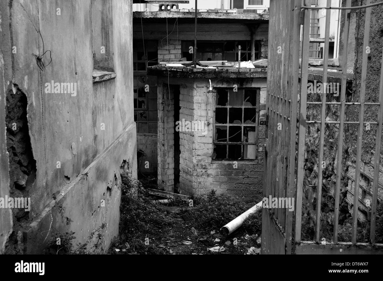 Cancello arrugginito di un magazzino abbandonato. In bianco e nero. Foto Stock
