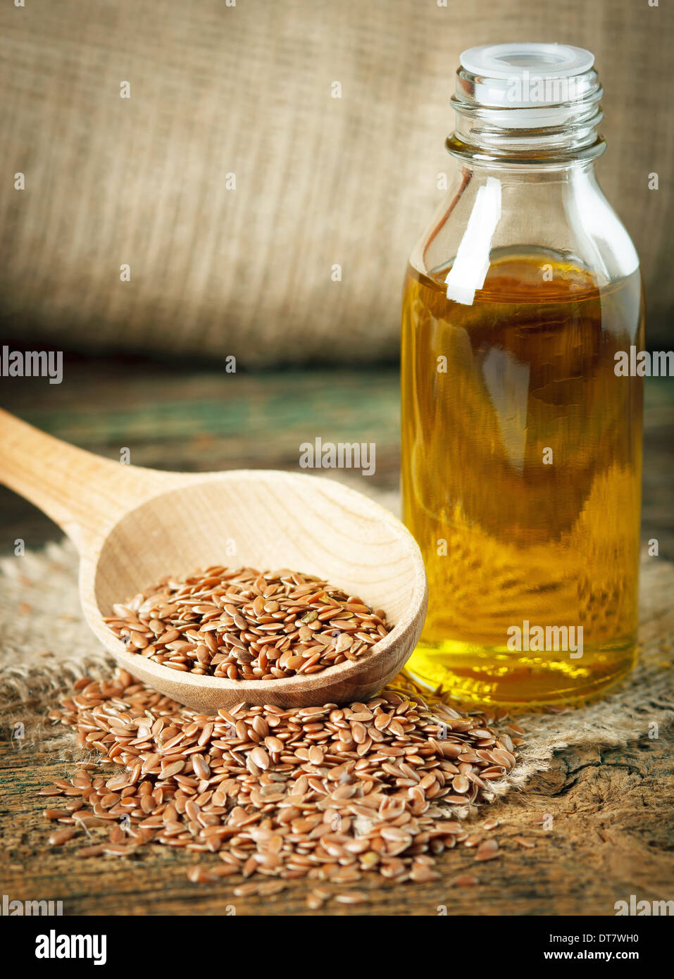 Olio di semi di lino e semi di lino sul cucchiaio di legno Foto Stock