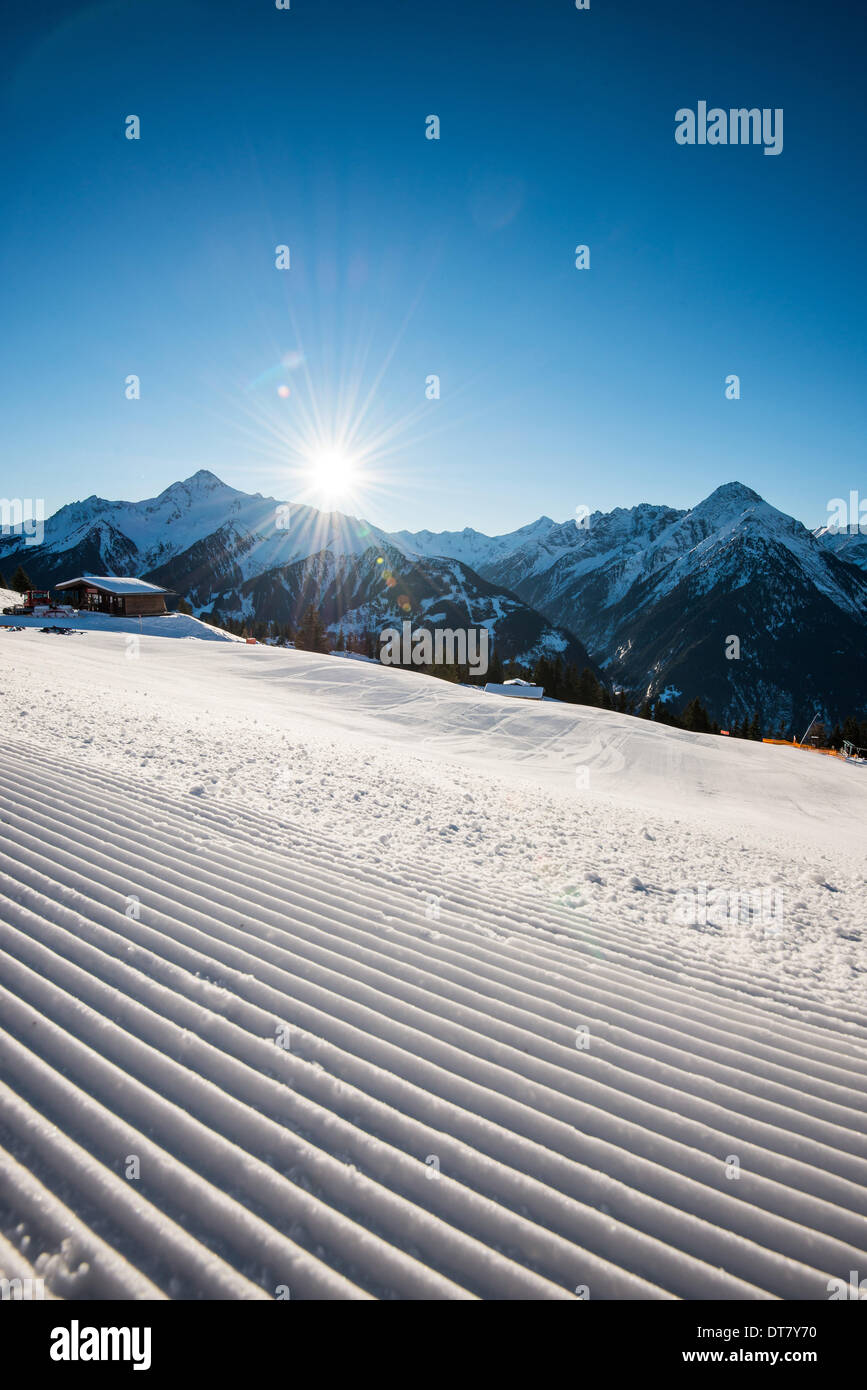 Il sole splende su un dolce pendio preparati su una montagna presso la stazione sciistica di Mayrhofen in Tirolo, Austria. - Dicembre 2013 Foto Stock