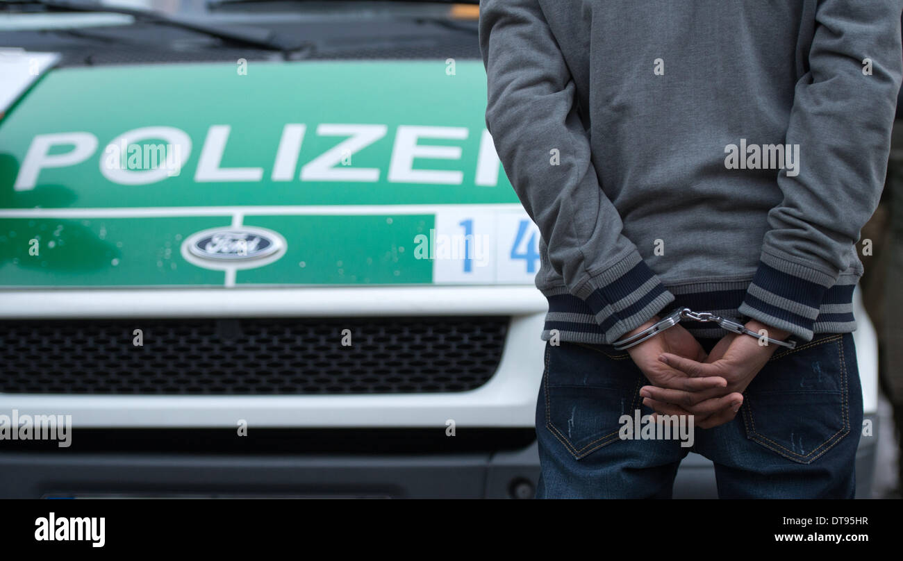Berlino, Germania. 10 Febbraio, 2014. Un arrestato presunto spacciatore di droga sta ammanettato nella parte anteriore di una macchina della polizia a Berlino, Germania, 10 febbraio 2014. Nel corso di un raid di droga a Goerlitzer park la polizia controllare 49 persone e ha avviato il procedimento di nove per spaccio di droga. 69 sacchetti contenenti farmaci, quattro ampullas con anfetamine e tre sfere di eroina sono stati sequestrati. Foto: Bernd von Jutrczenka/dpa/Alamy Live News Foto Stock