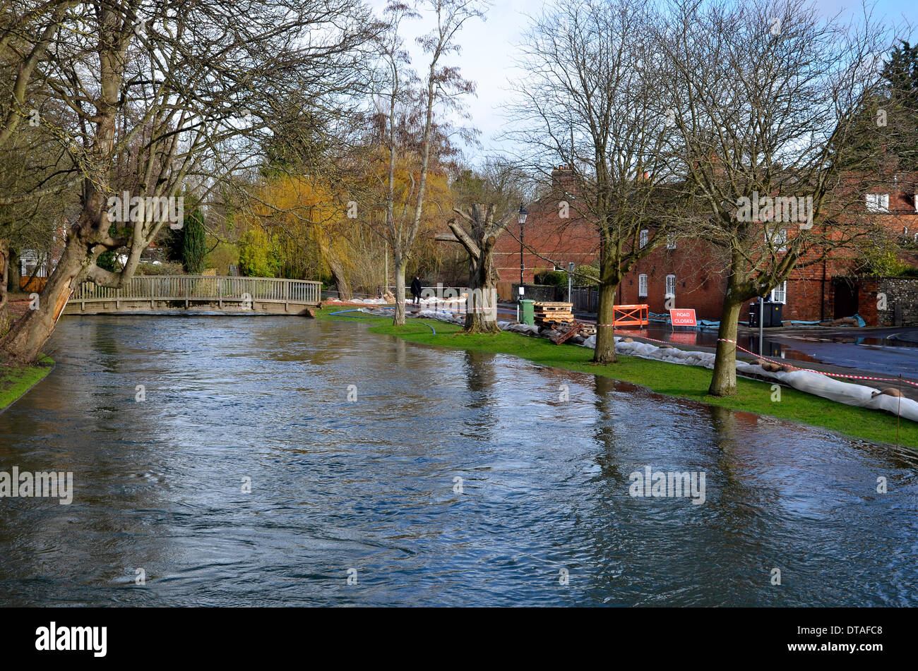 Il fiume Itchen trabocca lungo la corsia di acqua vicino al centro della città di Winchester, il capoluogo della contea di Hampshire. Il personale della marina militare hanno eretto contrappeso bunds nel tentativo di contenere l'acqua ed evitare le inondazioni di proprietà. Foto Stock