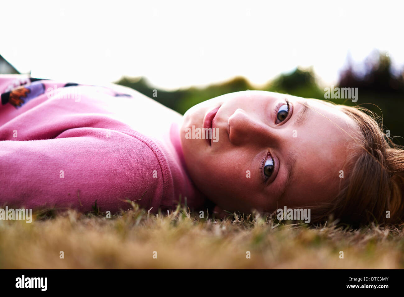 Close up ritratto di una ragazza che giace sull'erba Foto Stock