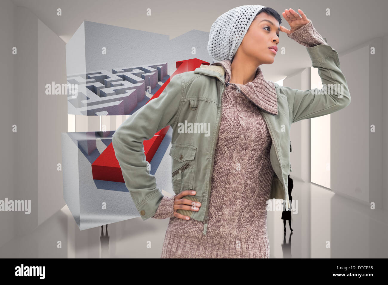 Immagine composita di concentrato di giovani modello in abbigliamento invernale guardando intorno a lei Foto Stock