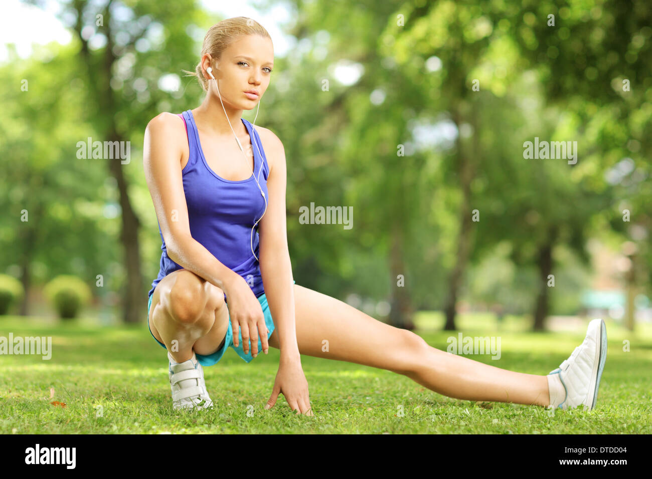 Giovane donna bionda che esercitano in un parco sulla giornata di sole Foto Stock
