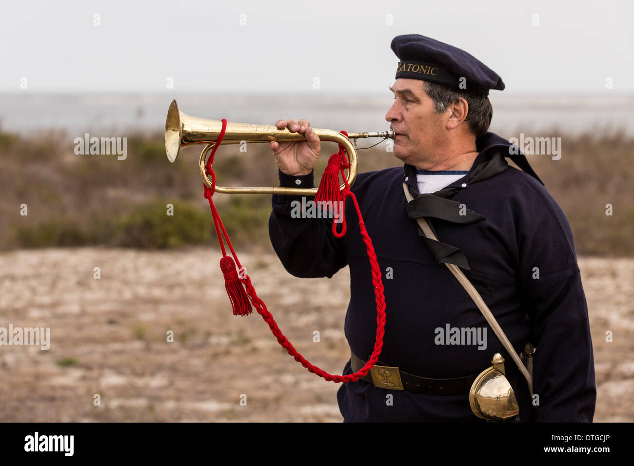 Un solitario gioca bugler rubinetti lungo la violazione ingresso in onore dei marinai dell'Unione nave della marina americana USS Housatonic affondato dal sommergibile confederato H.L. Hunley a 150 anni fa durante la Guerra Civile, 17 febbraio 2014 su Sullivan's Island, SC. Il Hunley fu il primo sottomarino ad affondare una nave in battaglia e poi subito un incidente uccidendo l'equipaggio. Foto Stock