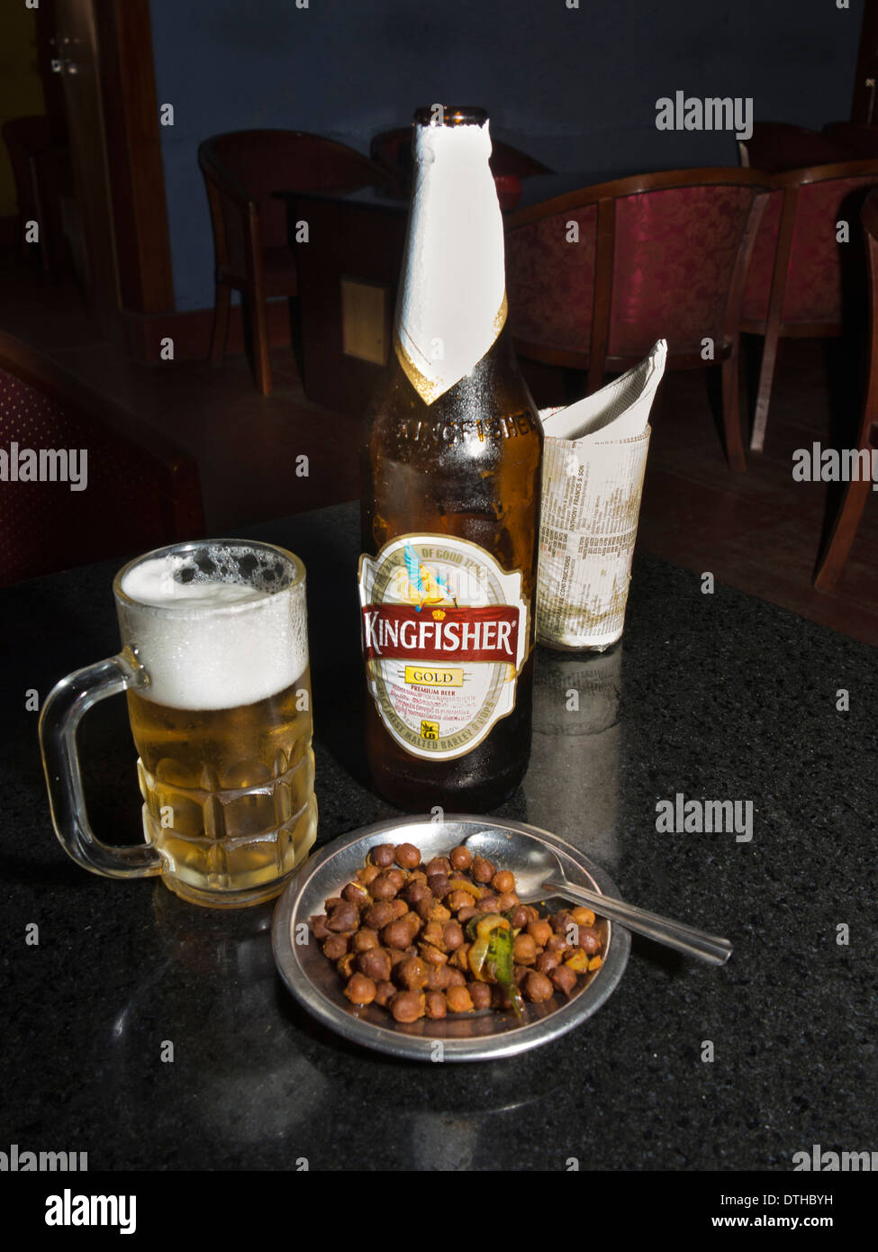 India Kerala, Fort Cochin, alcool, fredda birra Kingfisher e masala arachidi snack nel bar Foto Stock