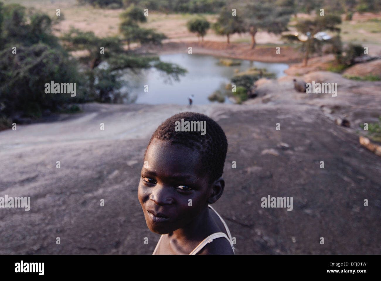 Uganda Karamoja Kotido, popolo Karimojong, tribù pastorale, ragazzo al posto di acqua Foto Stock