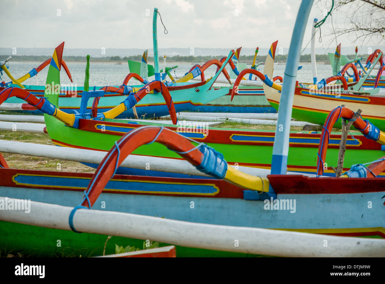 Barche colorate di rosso verde giallo blu sulla spiaggia nel tardo pomeriggio con nessuno Sanur Thailandia Foto Stock