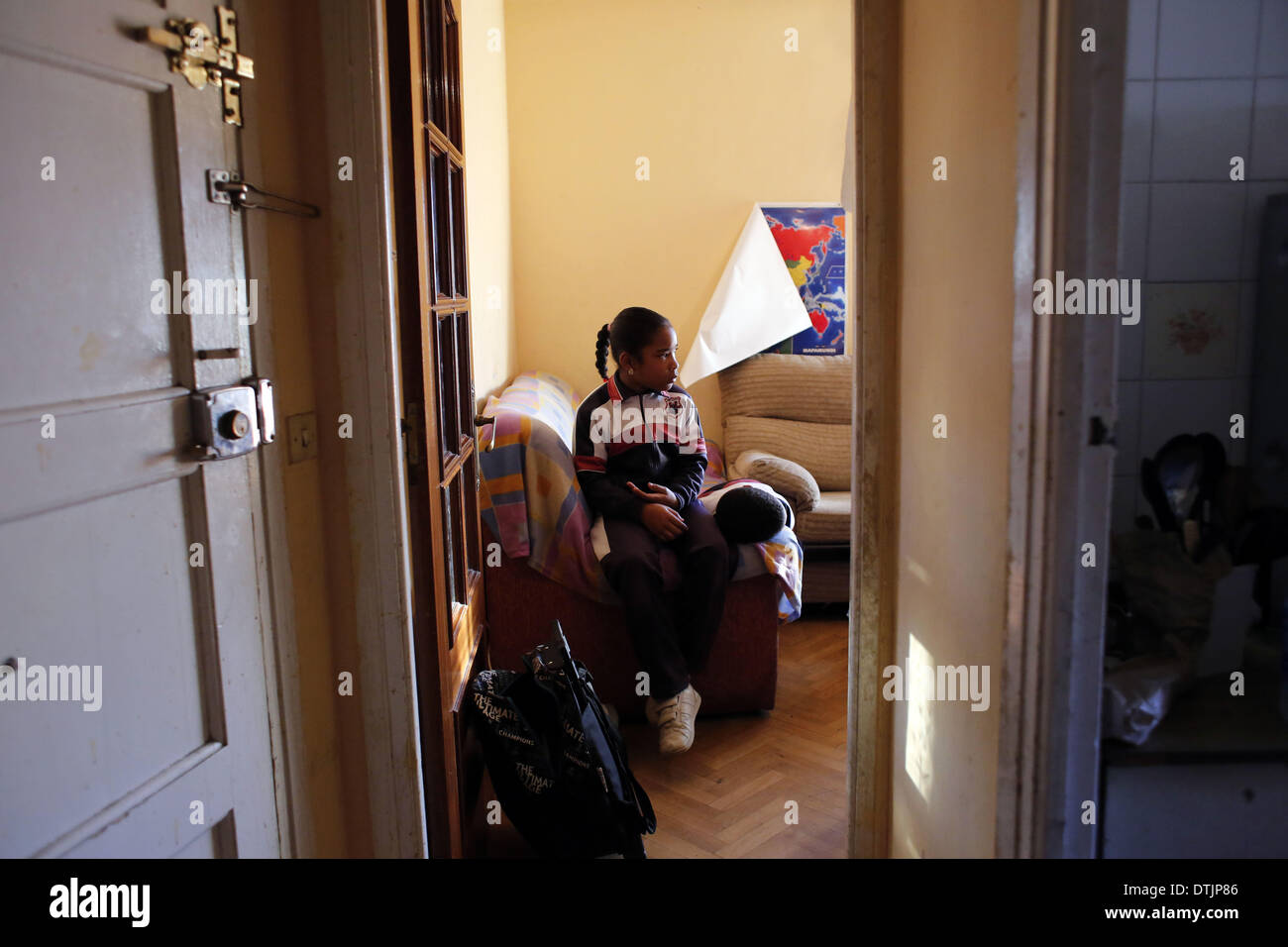 Madrid, Spagna. 19 feb 2014. 9 anno-vecchio Raquel Concepcion Menendez e 6 anno-vecchio Jean-Carlos ConcepciÃƒÂ³n Menendez guardare la TV prima di andare a scuola in attesa di essere sfrattati dalla loro casa in Spagna a Madrid, mercoledì, 19 febbraio 2014. Maria Menendez Melendez 29 anni da Repubblica Dominicana ha vissuto per otto anni con il suo compagno Carlos e i loro due bambini, Raquel ConcepciÃƒÂ³n Menendez 9 anno-vecchio e Jean Carlos Concepcion Menendez 6 anno-vecchio, in un appartamento di proprietà di ''La camma -Sabadell'' con cui hanno contratto un mutuo che non hanno pagato per 6 anni.Prima di becom Foto Stock