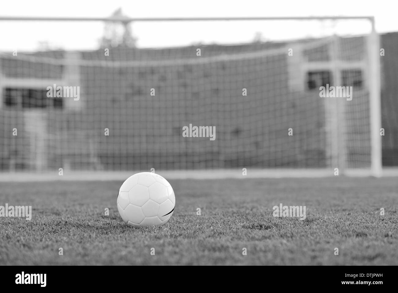 Pallone da calcio in erba a obiettivo e stadium in background Foto Stock