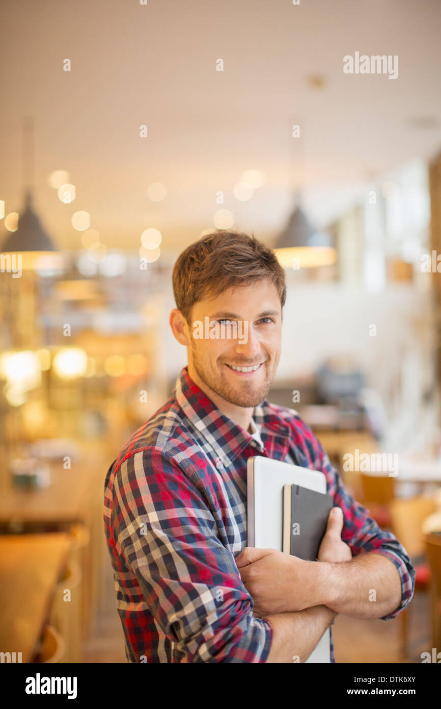 Uomo con libri in cafe Foto Stock
