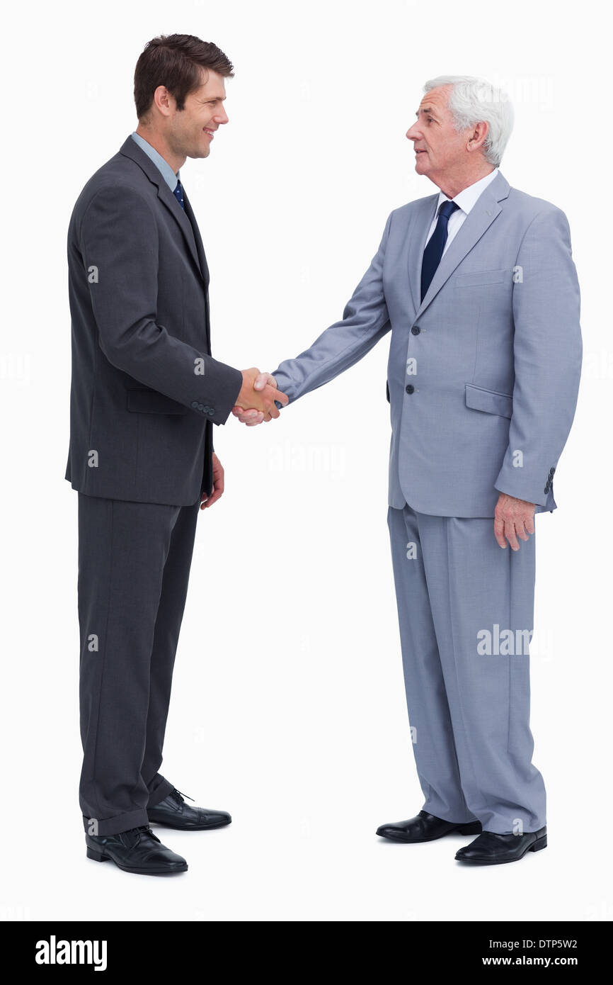 Giovane e maturo uomini d'affari stringono le mani Foto Stock