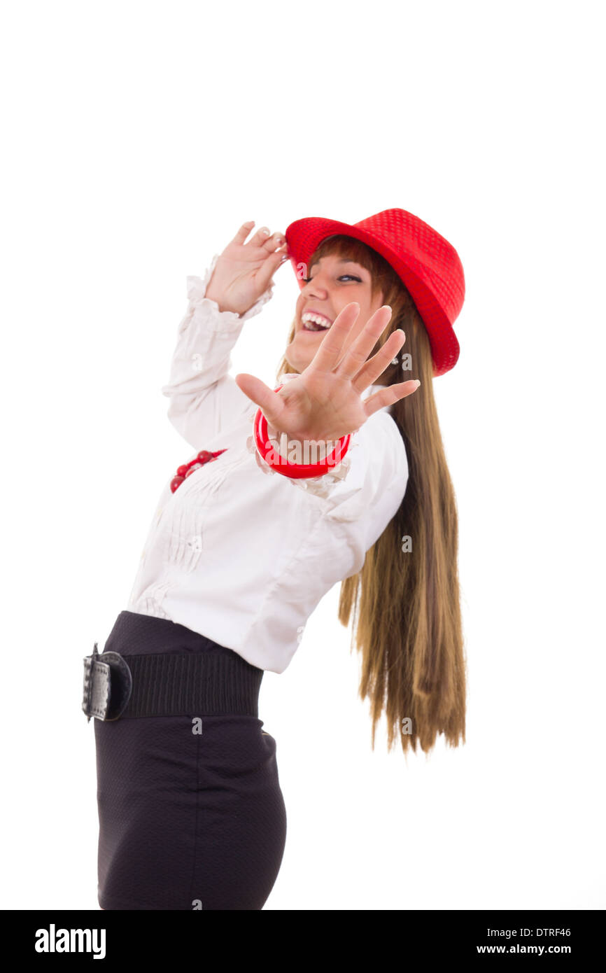 Bella ragazza sorridente con il Red Hat mostra fermo con la mano Foto Stock