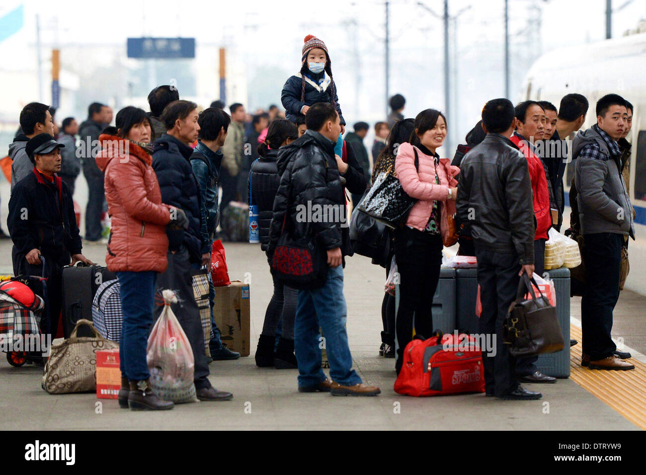 Hefei, cinese della provincia di Anhui. 24 Febbraio, 2014. Passeggeri coda per ottenere sui treni alla stazione ferroviaria di Hefei in Hefei, a est della capitale cinese della provincia di Anhui, Feb 24, 2014. Questo anno di "chunyun,' il picco periodo di viaggio che circonda la Cina del Festival di Primavera, è venuto a una stretta su Feb. 24 dopo 40-giornata movimentata di trasporto. © Zhang Duan/Xinhua/Alamy Live News Foto Stock