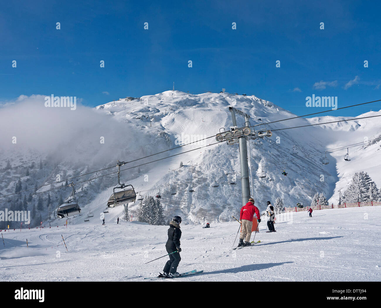 Gli sciatori che attraversa il sollevamento Mattun Gamfen dalla zona di sollevamento di St Anton in Austria Foto Stock