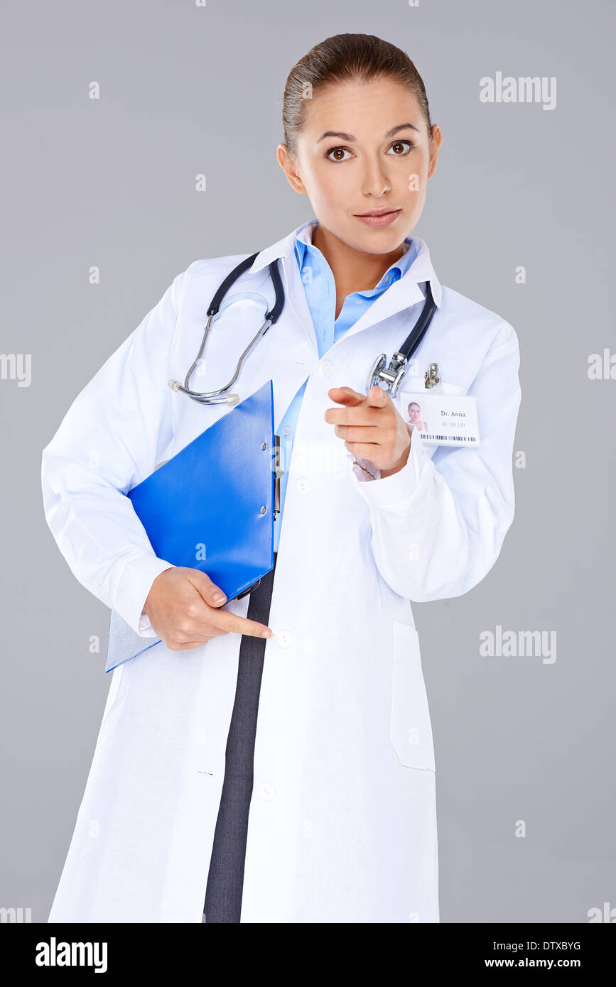 Giovane donna medico puntando verso la telecamera Foto Stock