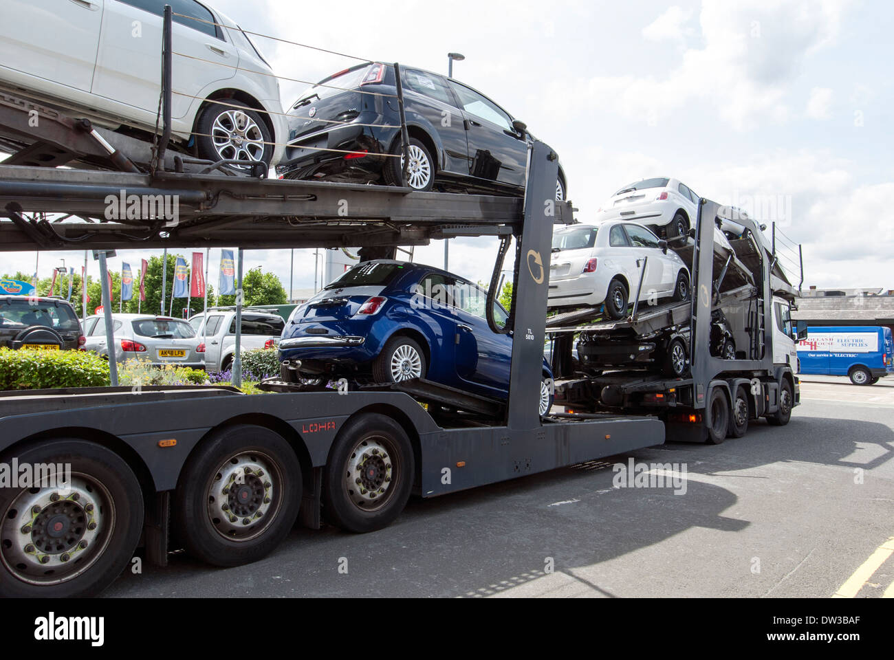 Auto transporter offrendo nuove vetture FIAT alla concessionaria in Warrington, Cheshire, Inghilterra, Regno Unito Foto Stock