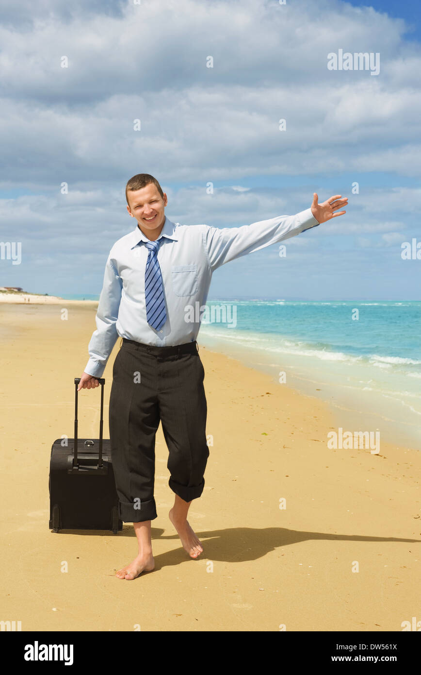 Imprenditore di camminare sulla spiaggia il primo giorno di vacanza Foto Stock