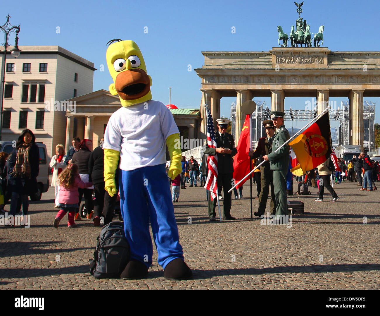 Gli uomini travestiti da soldati (indietro) e di Homer Simpson attendere per turisti alla Porta di Brandeburgo a Berlino, Ottobre 03, 2013. Sempre di più i turisti vengono a Berlino. La foto è parte di una serie sul turismo a Berlino. Foto. Wolfram Steinberg dpa Foto Stock