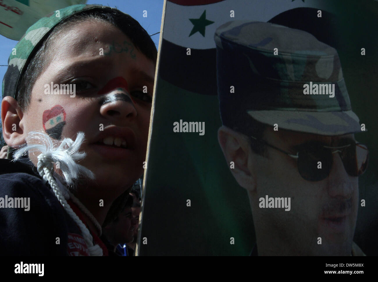Damasco, Siria. 28 feb 2014. Un ragazzo detiene un ritratto del Presidente siriano Bashar al-Assad durante un rally in Damasco, Siria, il 28 febbraio, 2014. Credito: Bassem Tellawi/Xinhua/Alamy Live News Foto Stock