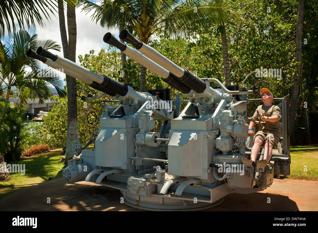 Ragazzo che guarda a pistole di difesa contraerea, Pearl Harbor, Oahu, Hawaii Foto Stock