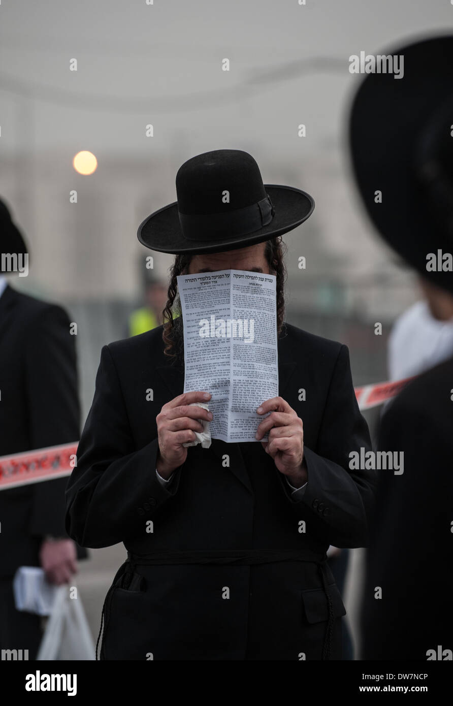 Gerusalemme. 2 Mar 2014. Un ultra-Ebrei Ortodossi prega durante una massa anti-progetto di rally in Gerusalemme, 2 marzo 2014. Centinaia di migliaia di ultra- ebrei ortodossi raccolse Domenica a Gerusalemme per protestare contro un piano del governo per arruolare i loro giovani nell'esercito. Il governo sta spingendo per un progetto di legge di reclutamento ultra-ortodossi e mettere le sanzioni penali, compresa la detenzione, su progetto di dodgers. Credito: Li Rui/Xinhua/Alamy Live News Foto Stock