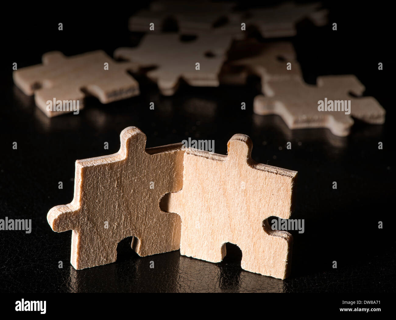 Puzzle in legno su sfondo nero. Close up Foto Stock