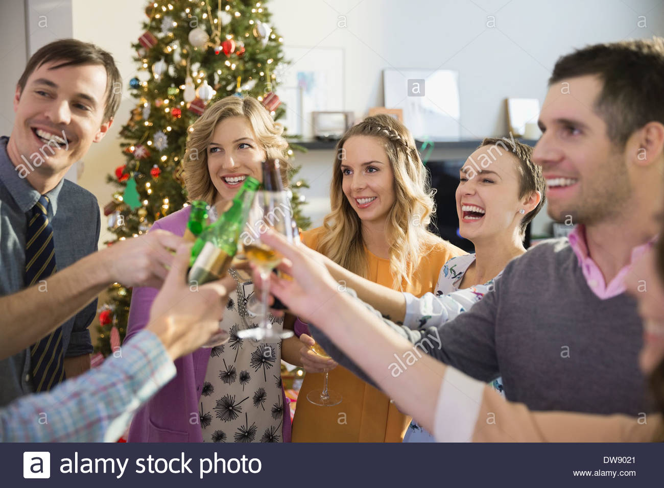 Amici di bevande di tostatura alla festa di Natale Foto Stock