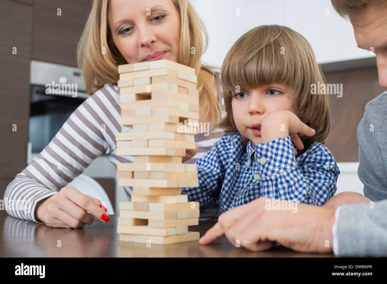 Famiglia giocando con dei blocchi di legno a casa Foto Stock