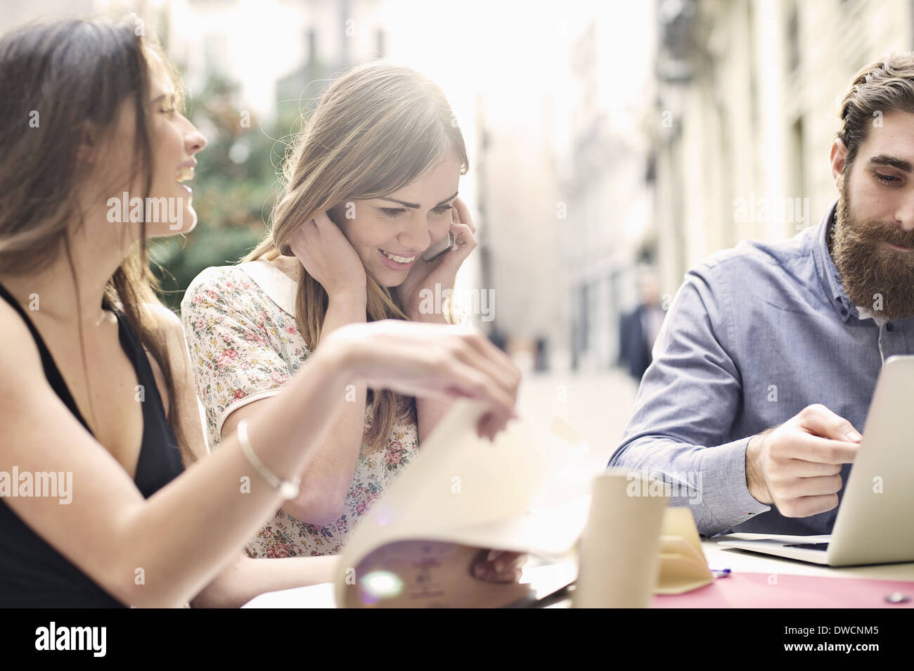 Tre amici turistica godendo una pausa al cafè sul marciapiede, Valencia, Spagna Foto Stock