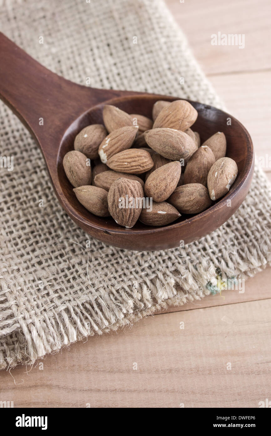 Mandorle kernel in cucchiaio di legno, close up foto Foto Stock