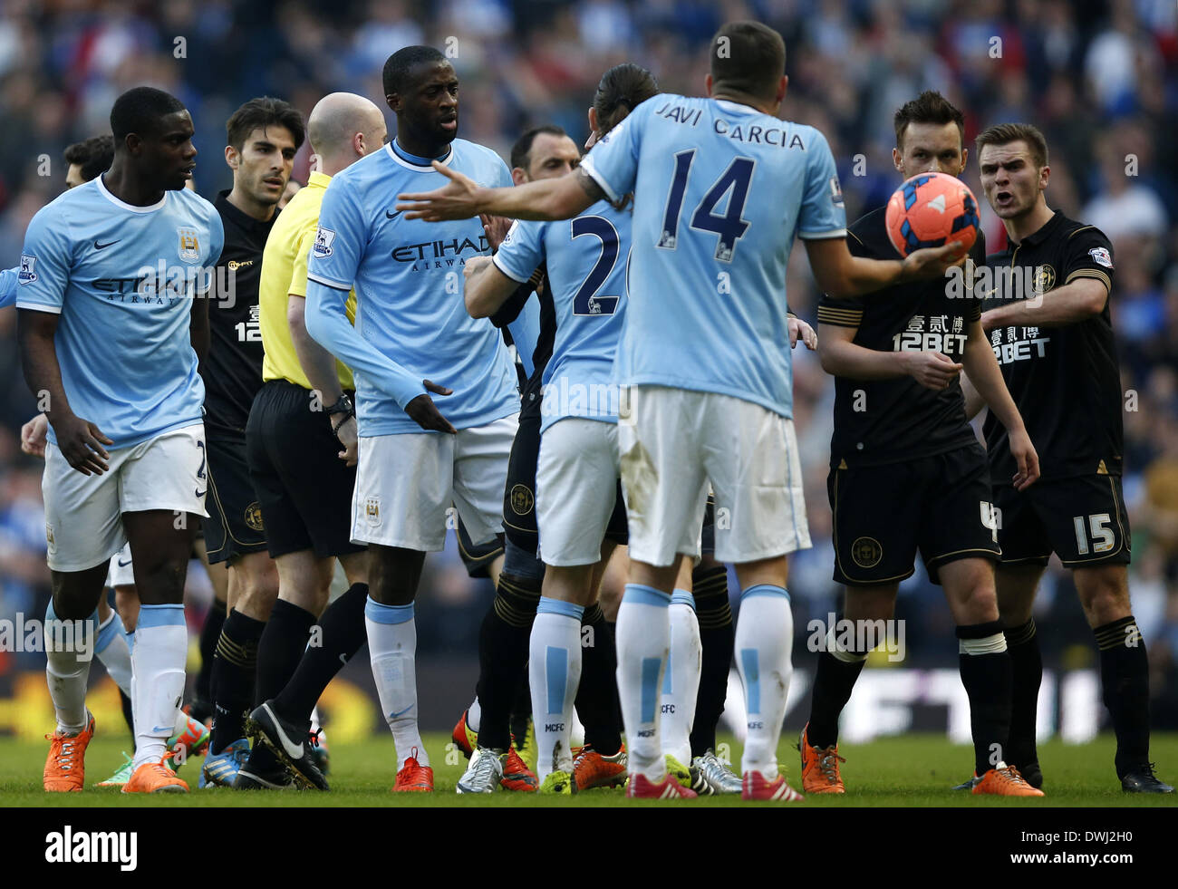 Manchester. 9 Mar 2014. I giocatori del Manchester City sostengono con i giocatori del Wigan durante la FA Cup quarterfinal match tra Manchester City e Wigan al Etihad Stadium di Manchester, Gran Bretagna il 9 marzo 2014. Il Manchester City ha perso 1-2. © Wang Lili/Xinhua/Alamy Live News Foto Stock