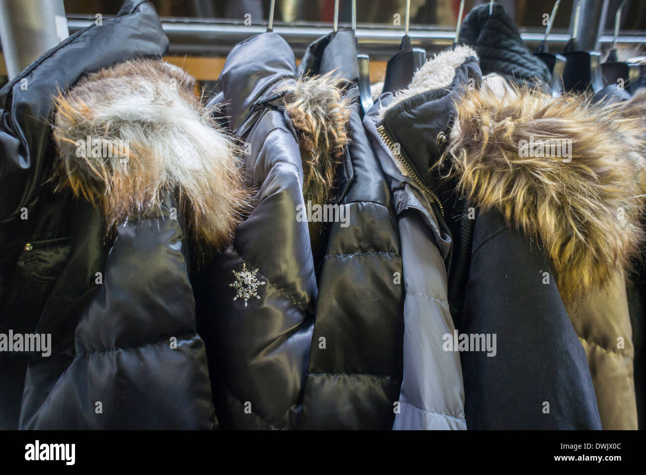 Una cremagliera di cappotti di pelliccia collari sono visto nel quartiere della moda, originariamente il Garment Center a New York Foto Stock