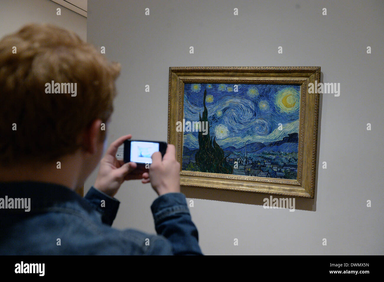 La città di New York, Stati Uniti d'America. 08 Mar, 2014. Un visitatore esamina il lavoro "Notte stellata" dall artista Vincent van Gogh presso il Museo di Arte Moderna (MoMA a New York City, Stati Uniti d'America, 08 marzo 2014. Foto: Felix Hoerhager/dpa/Alamy Live News Foto Stock