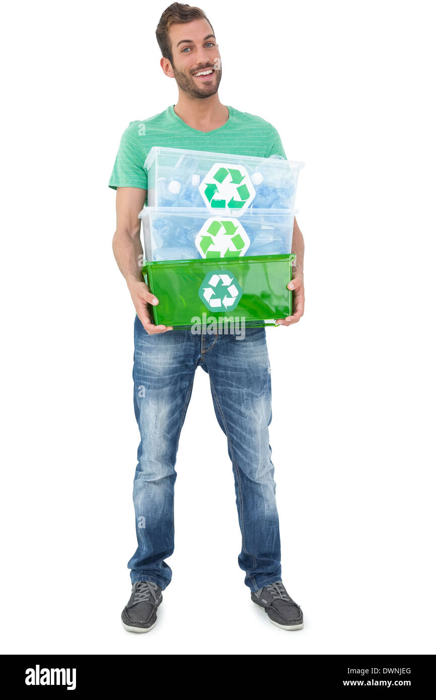 Ritratto di un sorridente giovane uomo che trasportano contenitori di riciclo Foto Stock