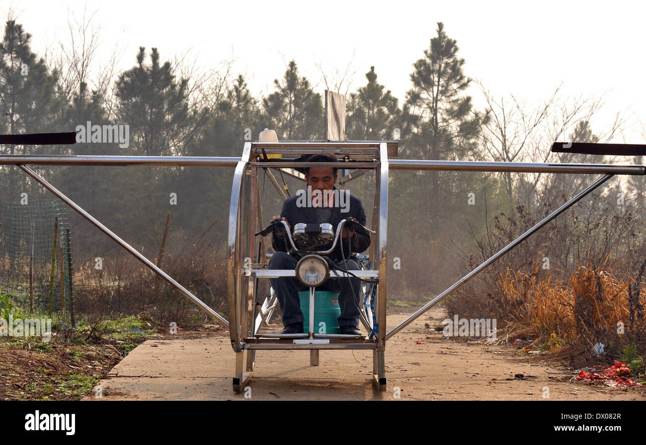 Miluo, Cina. Marzo 16, 2014 (Xinhua) -- Agricoltore Li processi Housheng parti per migliorare il suo helicopeter Ganzhou nel villaggio di Baitang township di Miluo City, centrale provincia cinese di Hunan, Marzo 14, 2014. Il contadino Li Housheng, 52, ha iniziato a fare il suo doppio rotore helicopeter fin dal mese di agosto 2013. Il helicopeter ha un motore trapiantato da un motociclo agricoli con scheletri fatta di ferro di angolo e di tubi di acciaio inossidabile. Ciascun rotore è semplicemente una saldatura di quattro piastre di acciaio. L'elicottero è sistema di controllo compresi acceleratore, frizione e joystick proviene da una motocicletta. Il helicopt Foto Stock