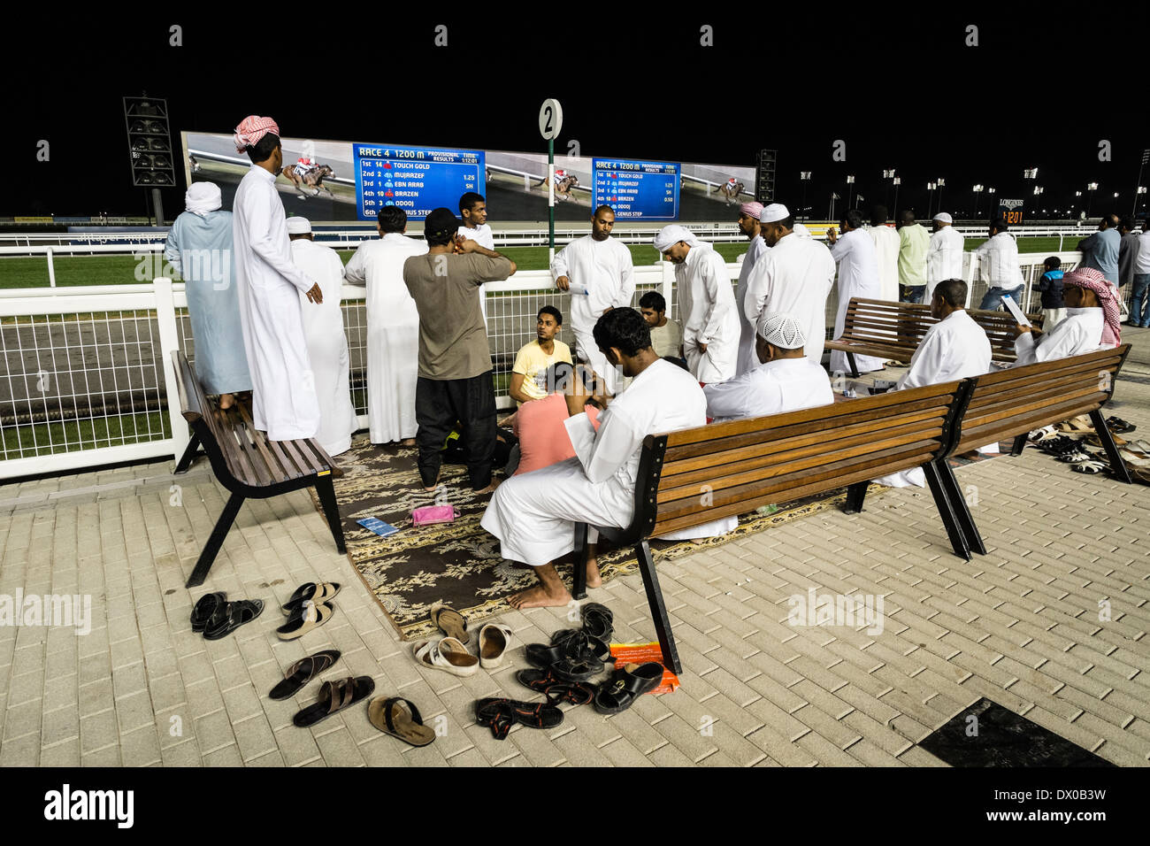 Gli spettatori a horse racing incontro presso Al Meydan Racecourse di notte in Dubai Emirati Arabi Uniti Foto Stock