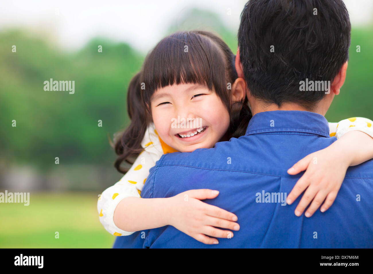 Felice bambina abbracciando abbracciando il suo padre Foto Stock