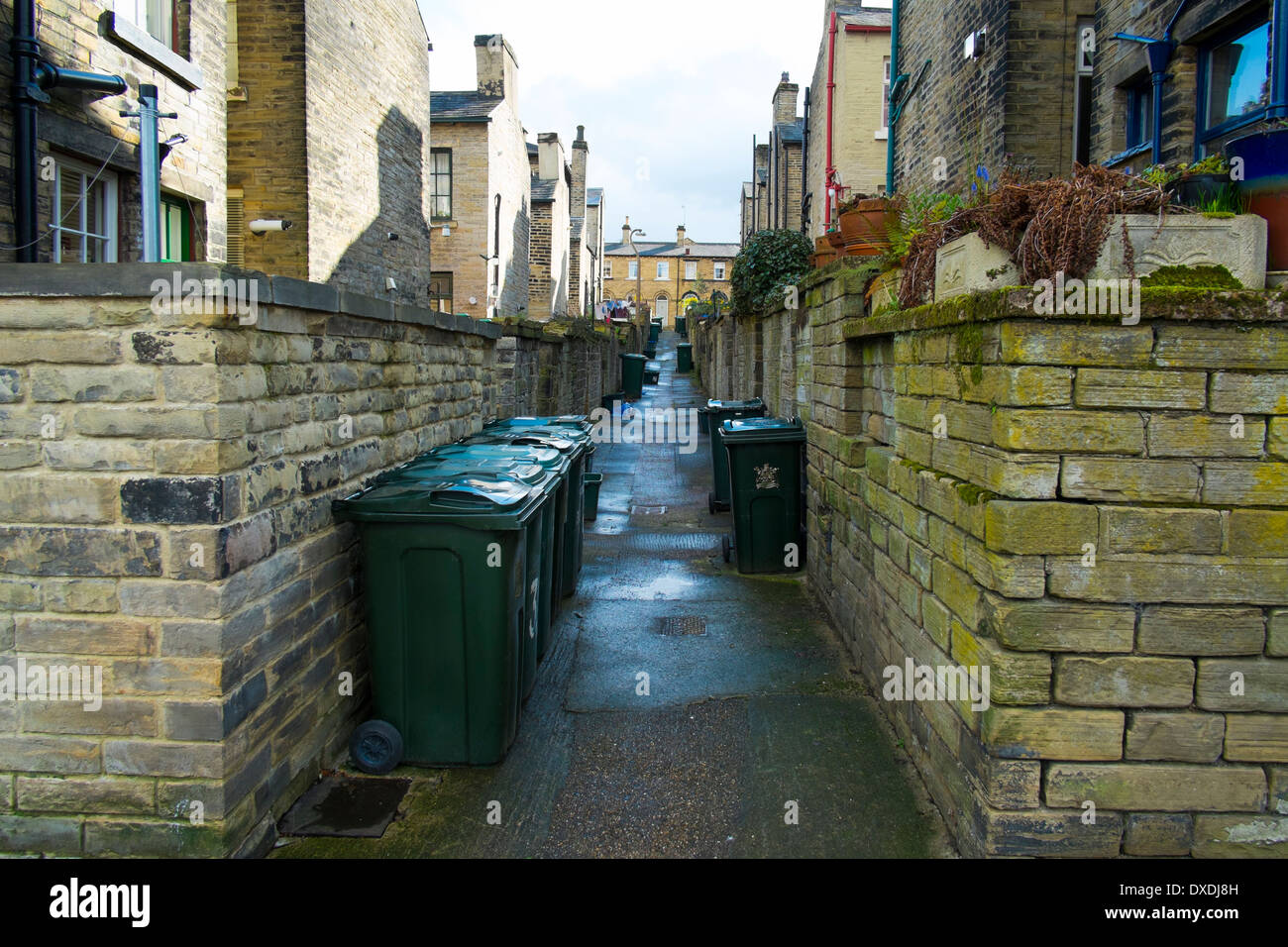 Cestini della spazzatura fuori di case costruite per i lavoratori al sale's Mill, Saltaire, Bradford, Yorkshire, Inghilterra. Foto Stock