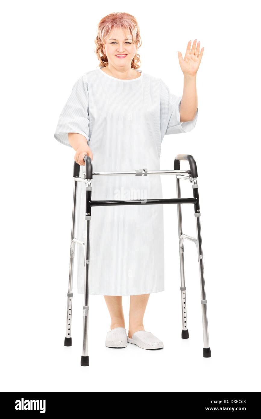 A piena lunghezza Ritratto di un paziente di sesso femminile con walker agitando con la mano Foto Stock