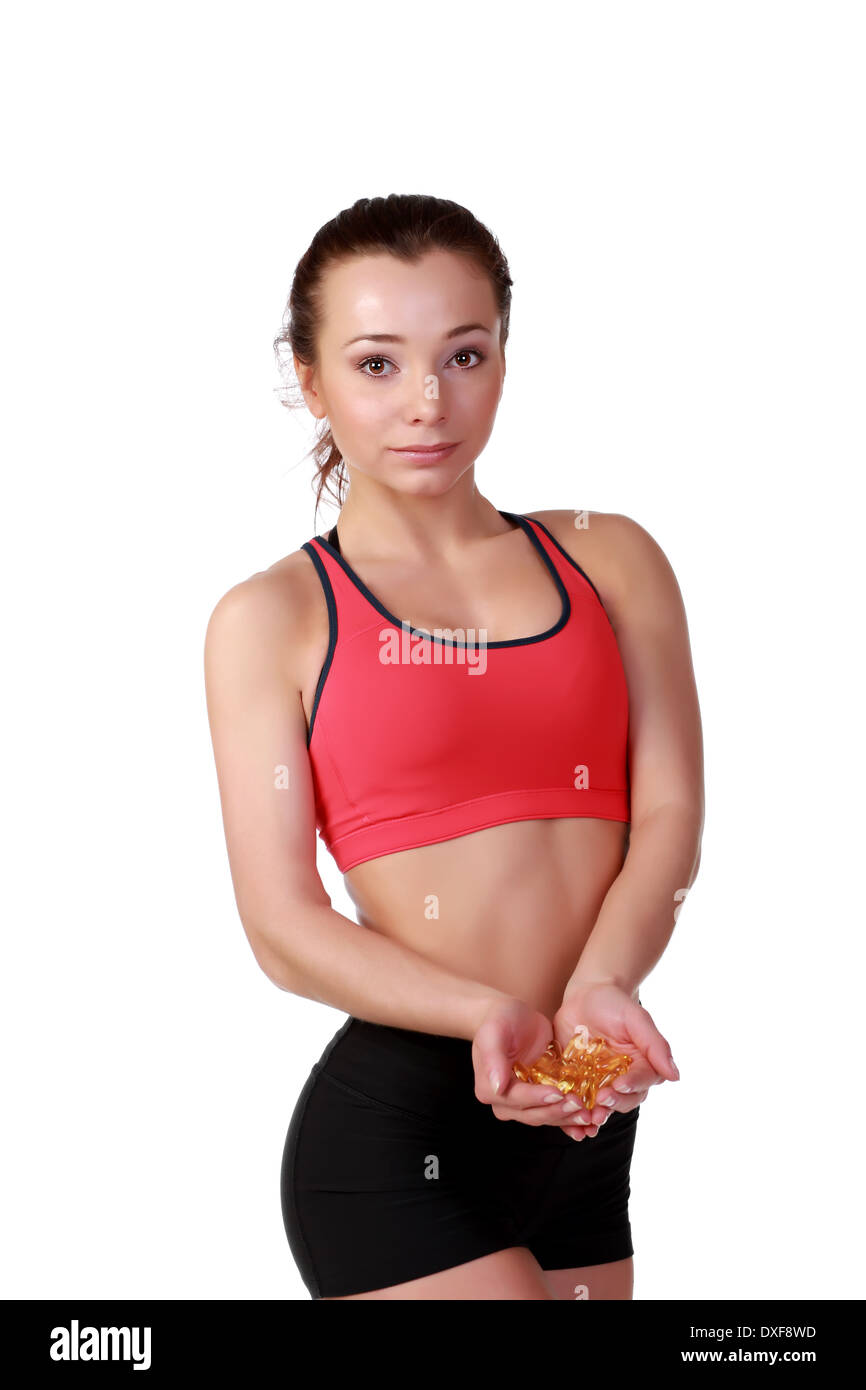 Femmina modello di fitness con Omega 3 pillole di acido Foto Stock