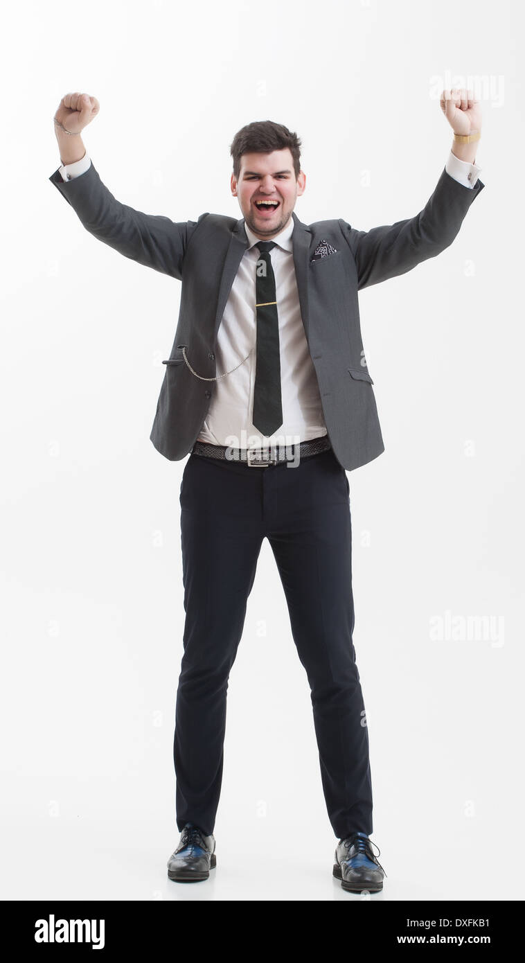 Imprenditore bello in un bel vestito che mostra segni con le mani. Alto uomo in grigio di una tuta. Foto Stock