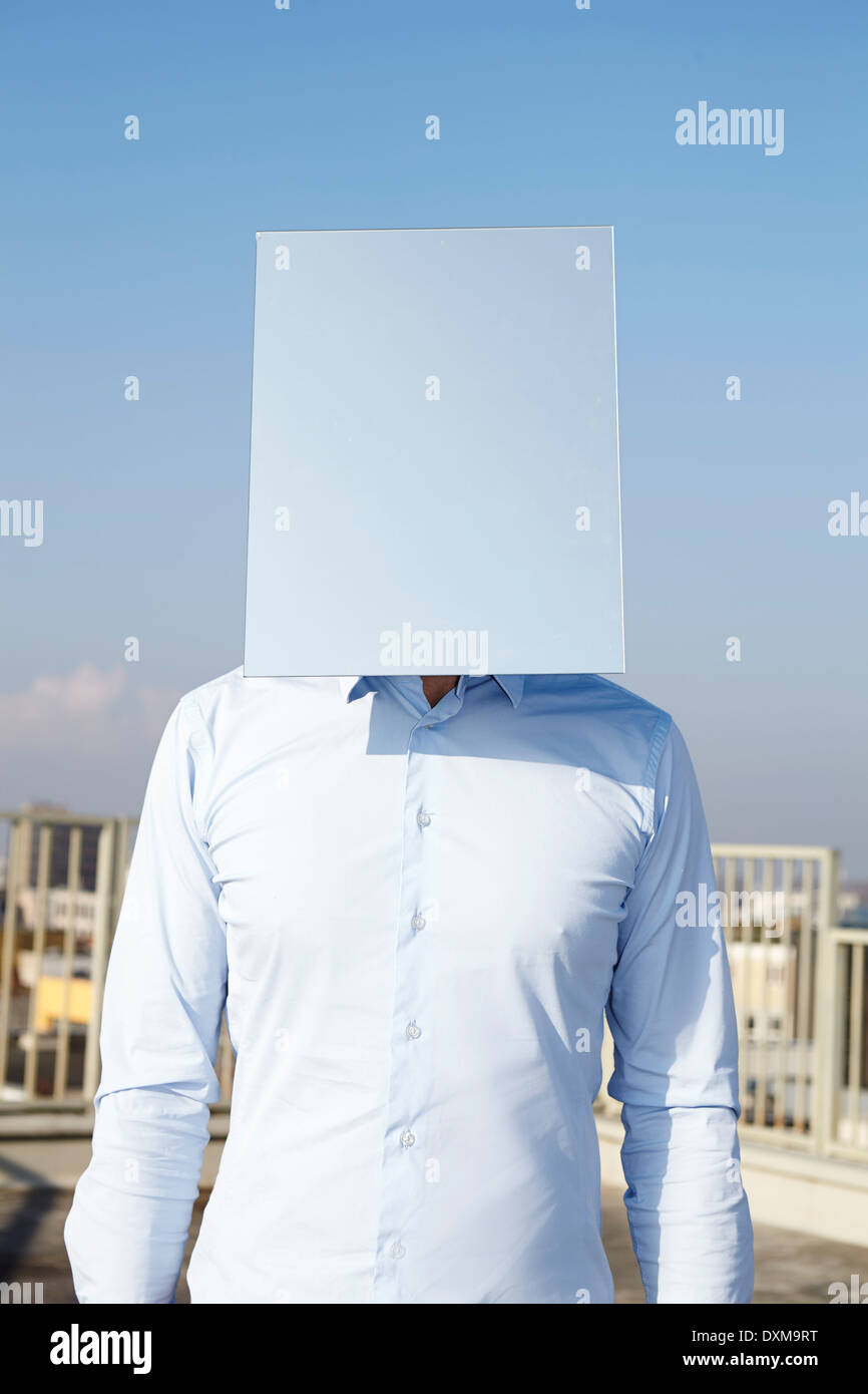 Il volto dell'uomo nascosto dietro la luce il rettangolo blu Foto Stock