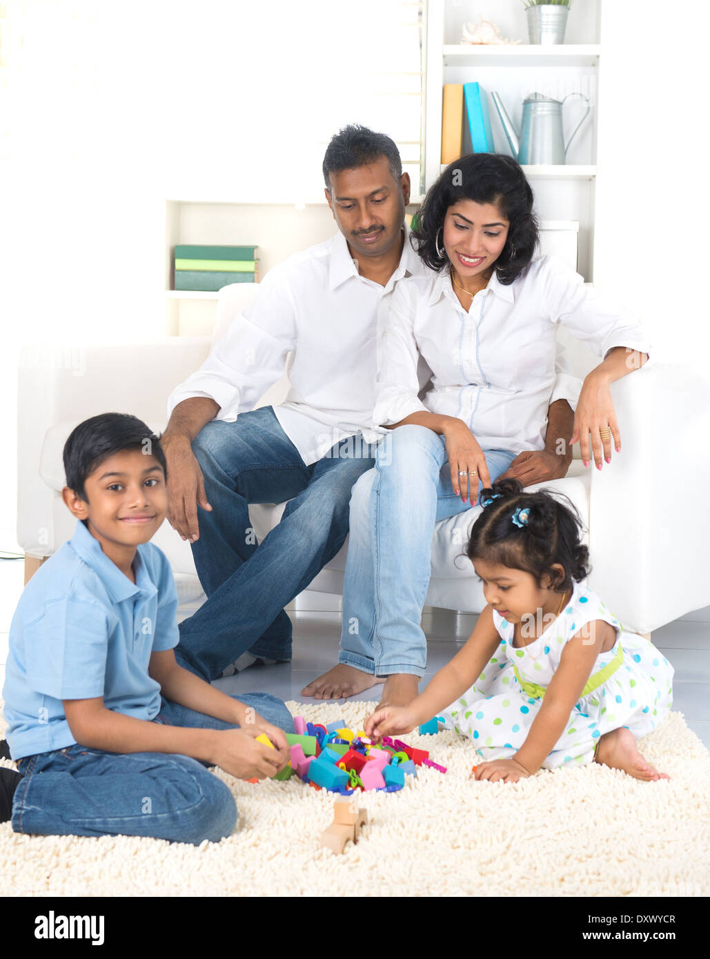 Felice famiglia indiana godendo del tempo di qualità indoor Foto Stock